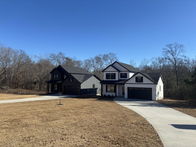 view of front of house featuring a garage and a front lawn