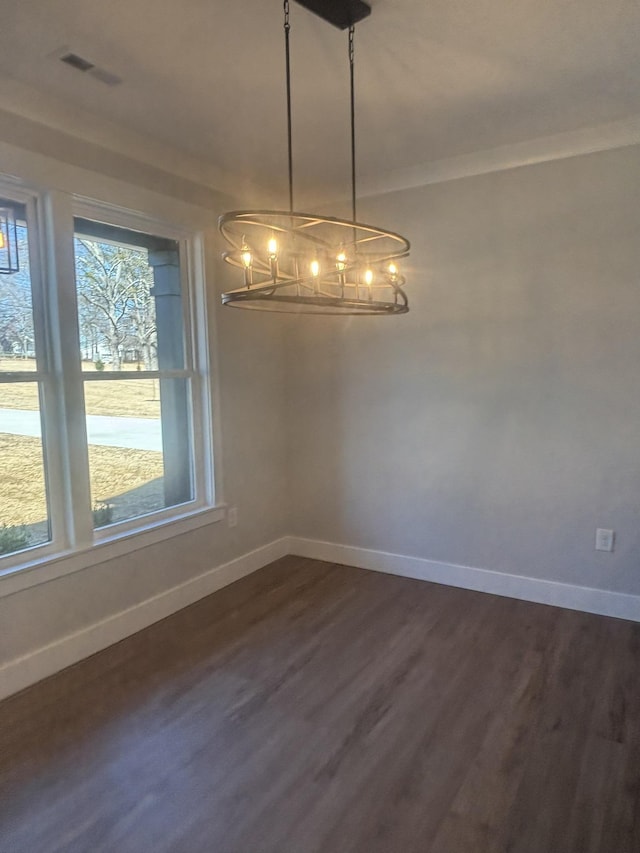 unfurnished dining area with dark wood-type flooring and ornamental molding