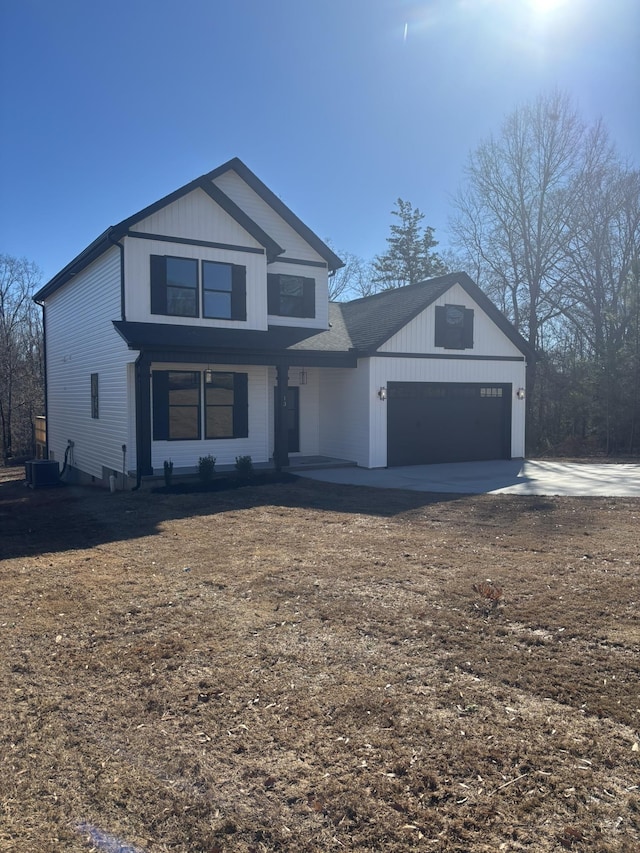 view of front of house with a garage and central AC