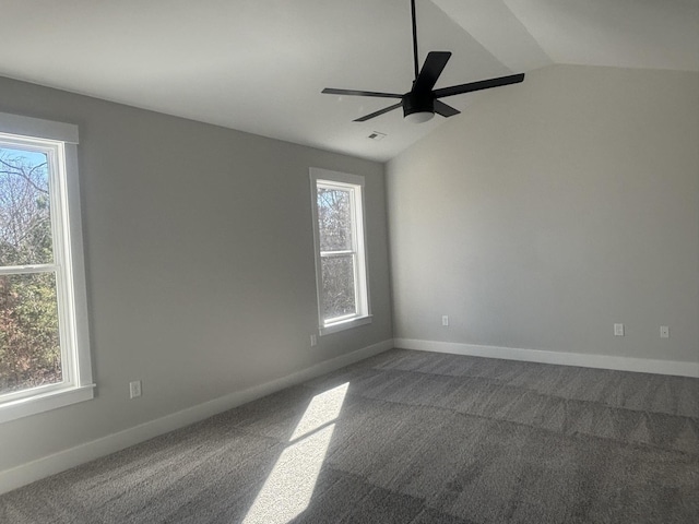 carpeted spare room with ceiling fan, lofted ceiling, and plenty of natural light