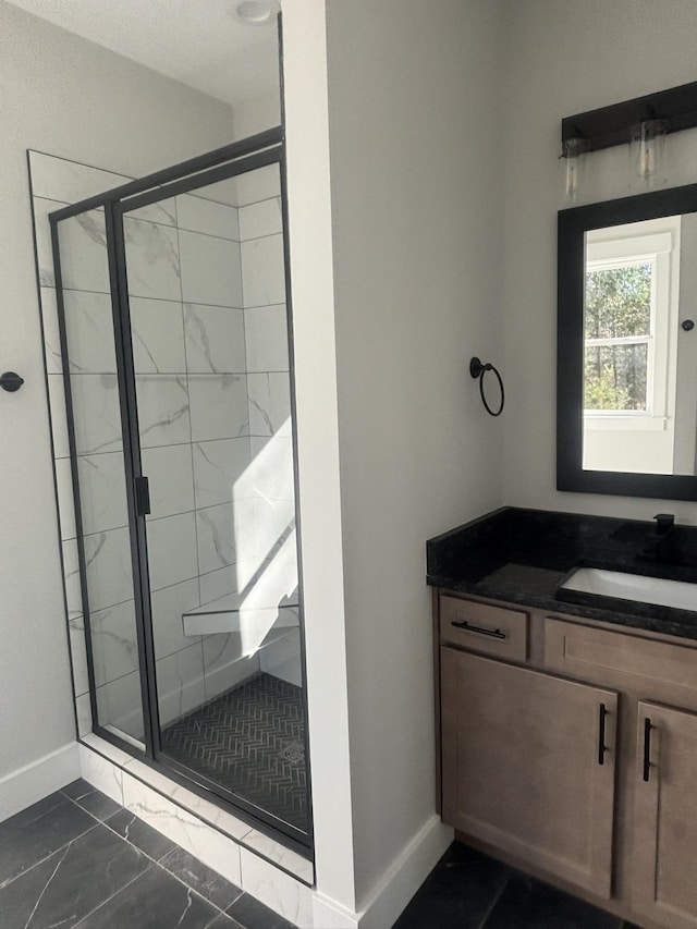 bathroom with a shower with door and vanity