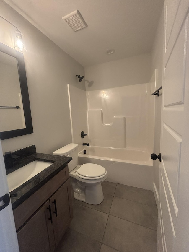 full bathroom with vanity, tub / shower combination, tile patterned floors, and toilet