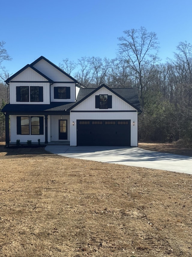 modern inspired farmhouse featuring a garage and a front lawn