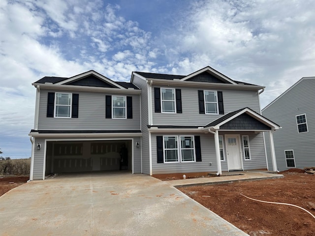 view of property featuring a garage and covered porch