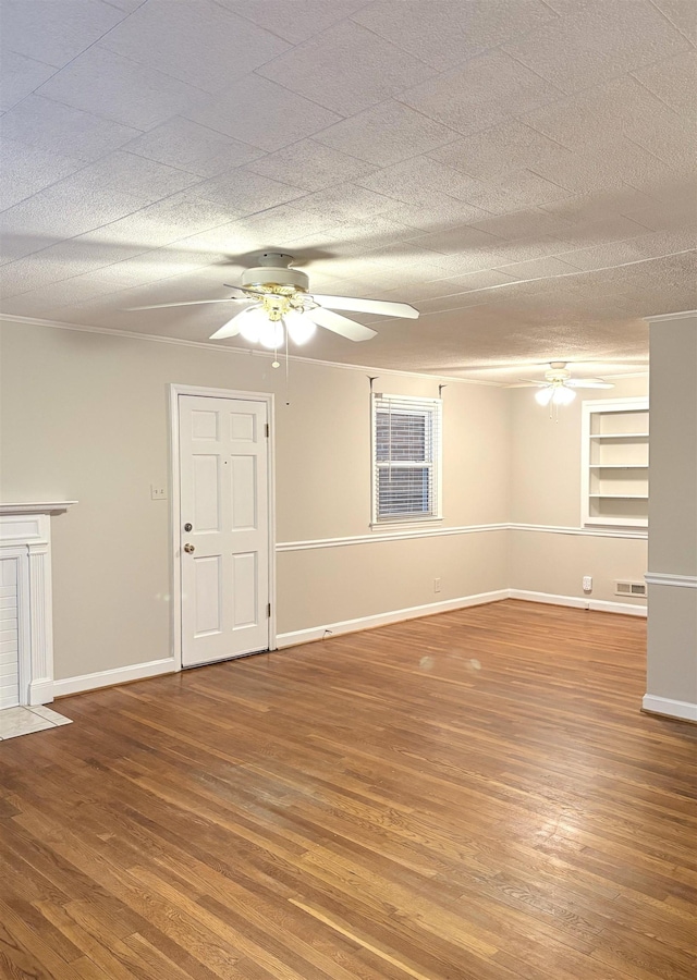 empty room featuring hardwood / wood-style floors, a textured ceiling, and ceiling fan