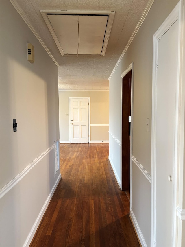 corridor with ornamental molding and dark hardwood / wood-style floors