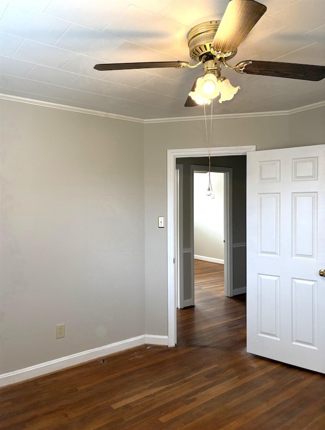 empty room featuring dark hardwood / wood-style flooring, ornamental molding, and ceiling fan