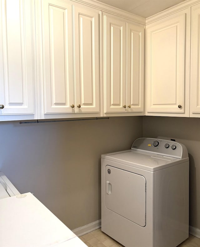 laundry room with cabinets and washer / dryer