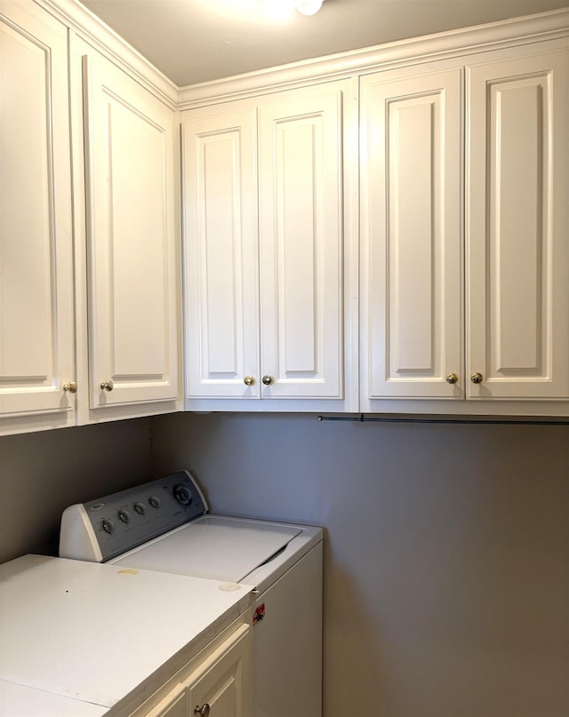 laundry room featuring cabinets and separate washer and dryer