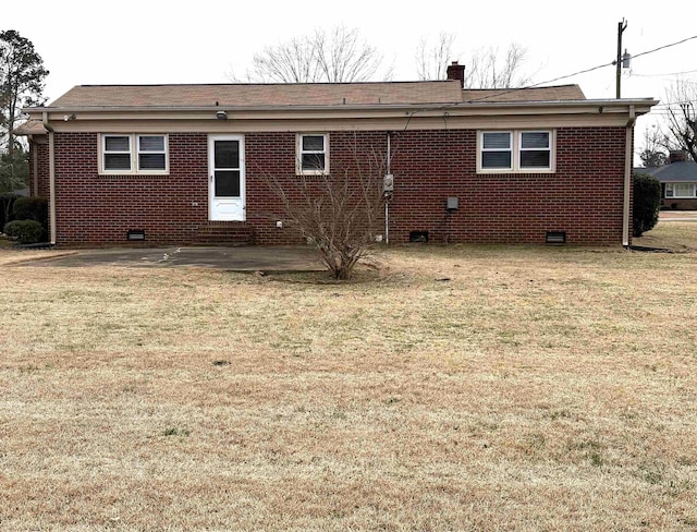 rear view of house with a yard and a patio area