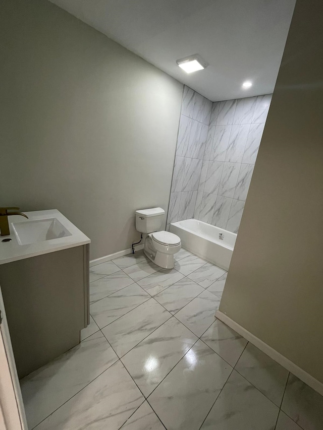 full bathroom featuring tiled shower / bath, vanity, and toilet