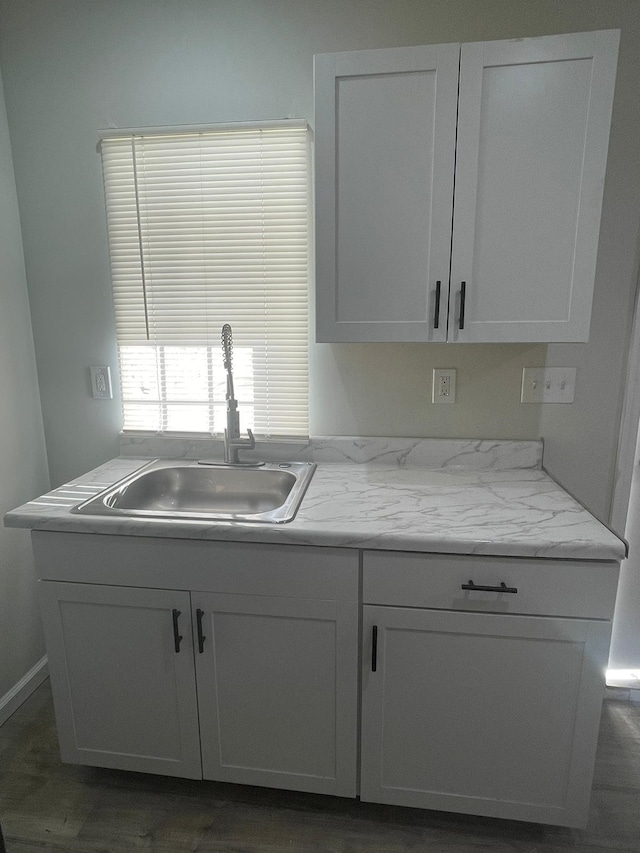 kitchen featuring sink and white cabinets