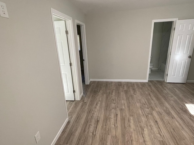 unfurnished room with hardwood / wood-style floors