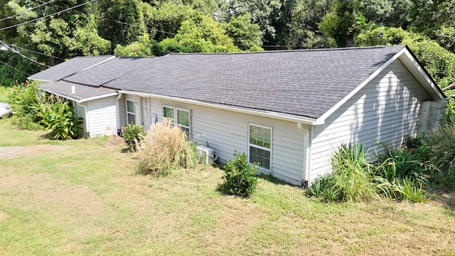 view of property exterior with a lawn