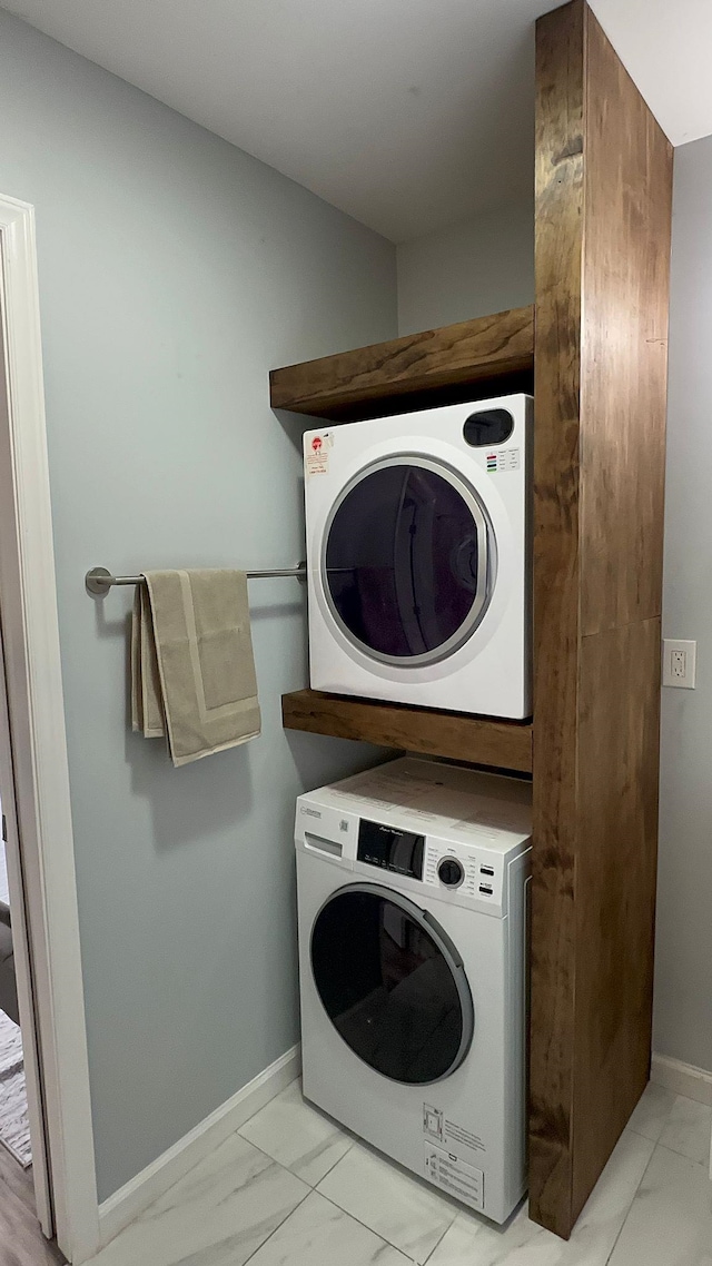 laundry area with stacked washing maching and dryer