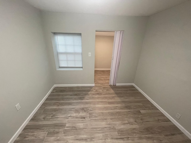 empty room with hardwood / wood-style floors