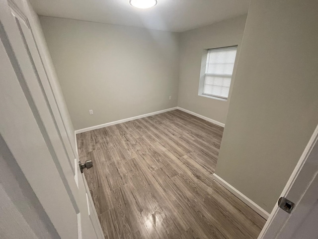 empty room with wood-type flooring