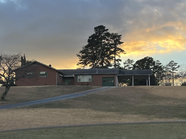 view of front of home with a carport and a garage