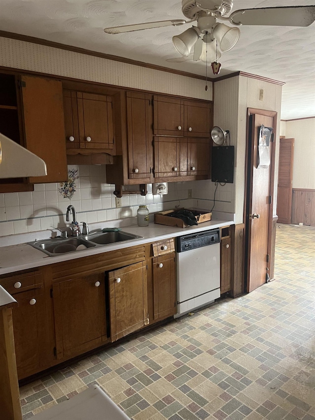 kitchen featuring sink, crown molding, dishwasher, ceiling fan, and backsplash