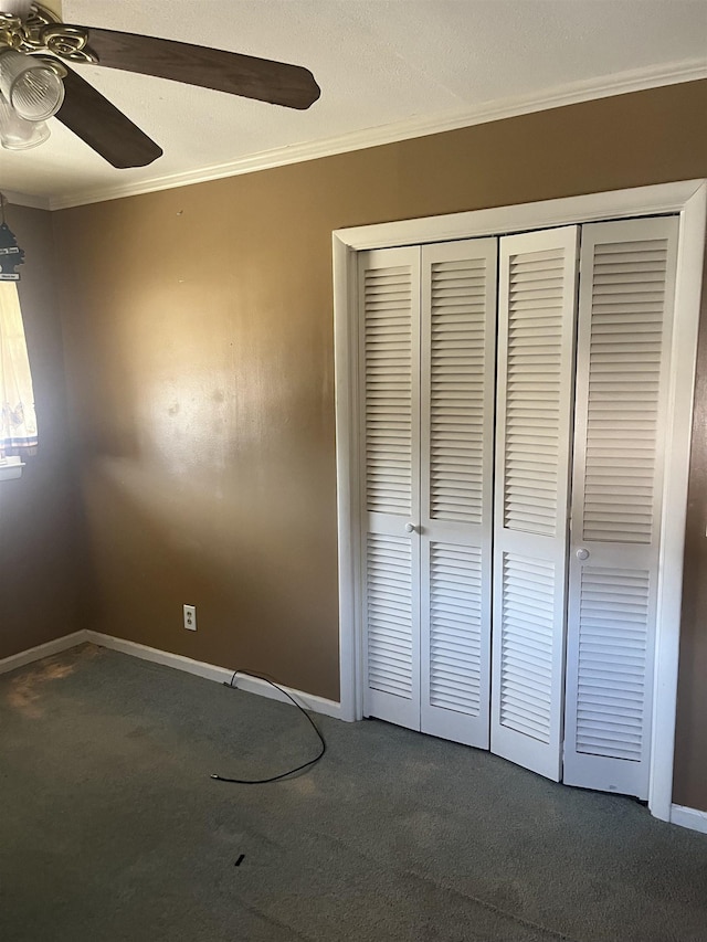 unfurnished bedroom with ornamental molding, a closet, and carpet