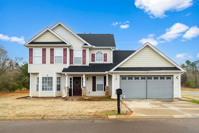 view of front of property featuring a garage and a front yard