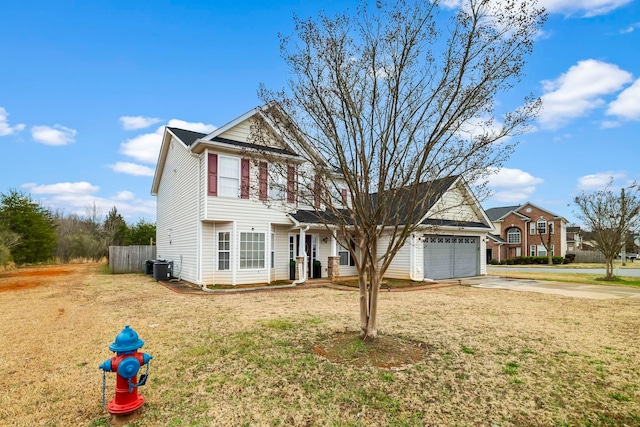 view of front property featuring a garage, central AC, and a front yard