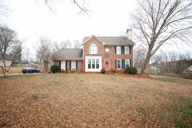 colonial inspired home with a front yard