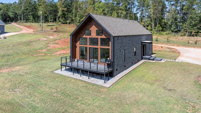 exterior space featuring a wooden deck and a yard