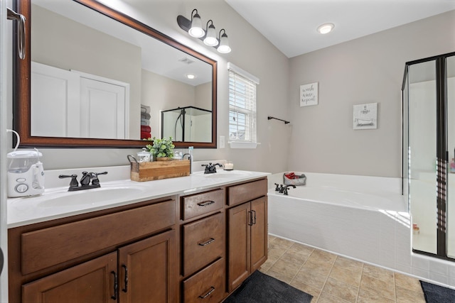 bathroom with tile patterned flooring, shower with separate bathtub, and vanity