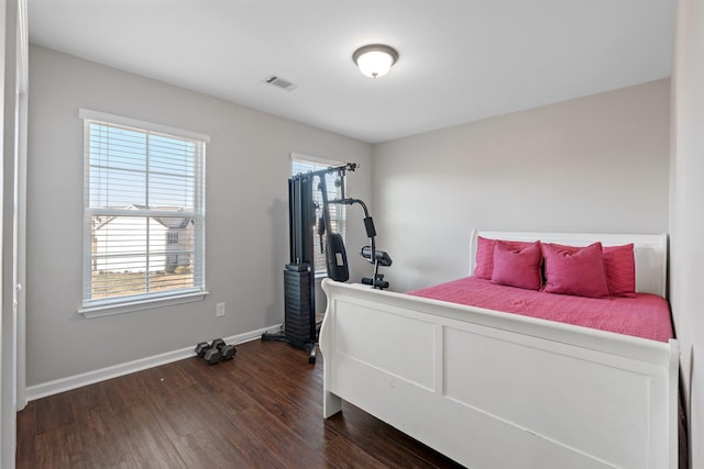 bedroom with dark hardwood / wood-style flooring