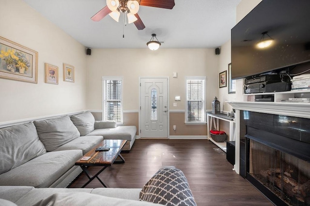 living room with dark wood-type flooring and ceiling fan