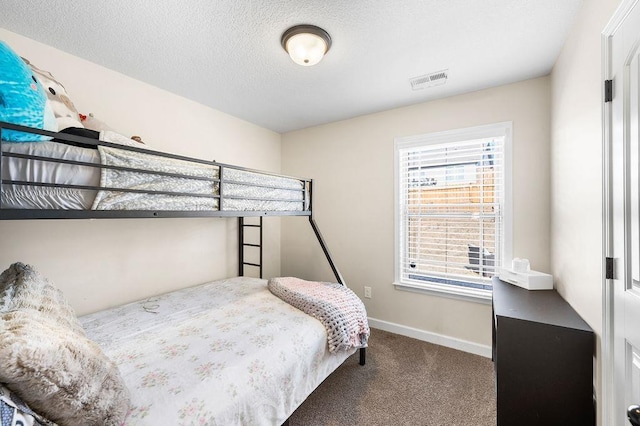 carpeted bedroom with a textured ceiling