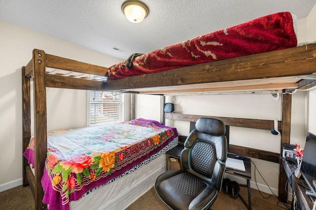 bedroom featuring a textured ceiling and carpet flooring