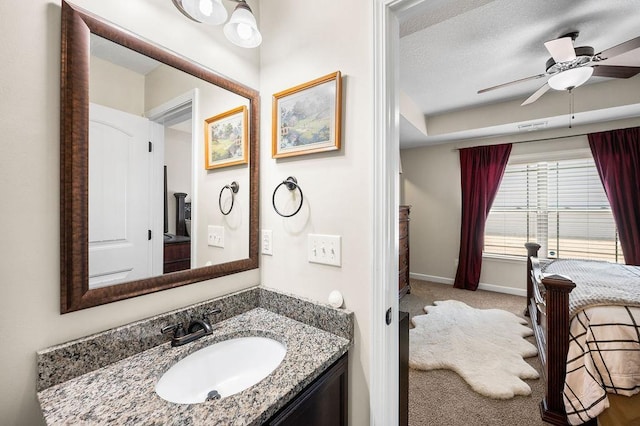 bathroom featuring vanity, a textured ceiling, and ceiling fan