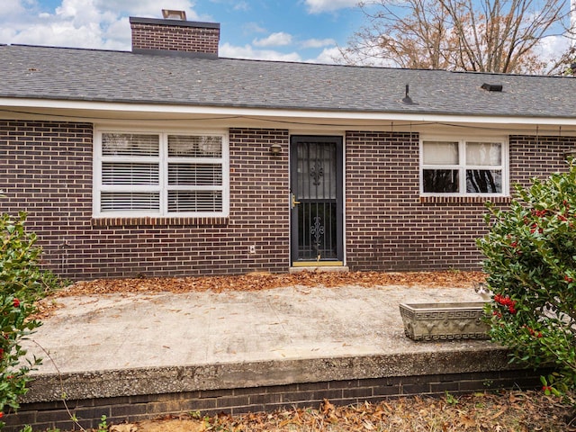 entrance to property featuring a patio