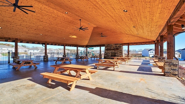 view of patio / terrace with a gazebo, an outdoor stone fireplace, and ceiling fan