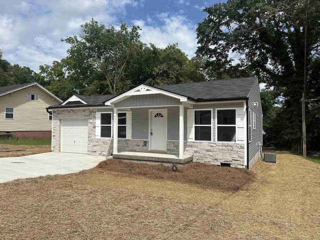 view of front of property featuring a garage, a porch, and cooling unit