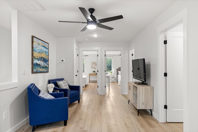 sitting room featuring ceiling fan and light wood-type flooring