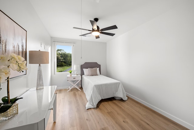 bedroom with light hardwood / wood-style flooring and ceiling fan