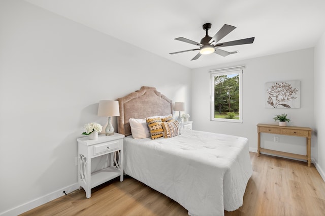 bedroom with ceiling fan and light hardwood / wood-style floors