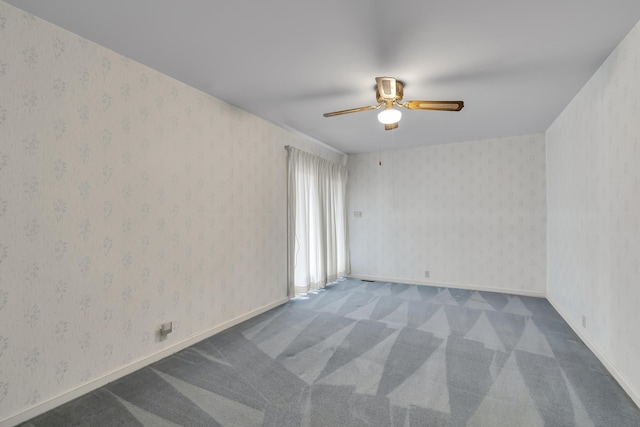 unfurnished room featuring ceiling fan and carpet flooring