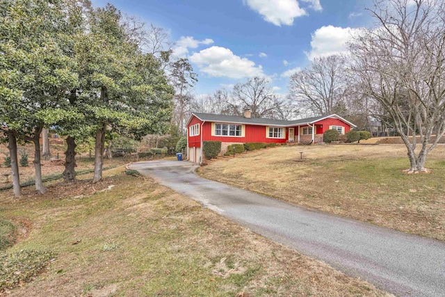 view of front facade with a garage and a front lawn