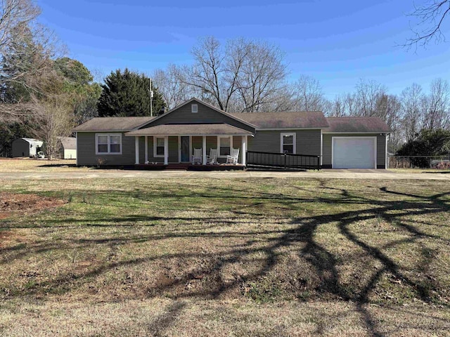 ranch-style home with a garage, a front yard, and covered porch