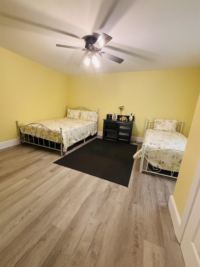 bedroom featuring wood-type flooring and ceiling fan