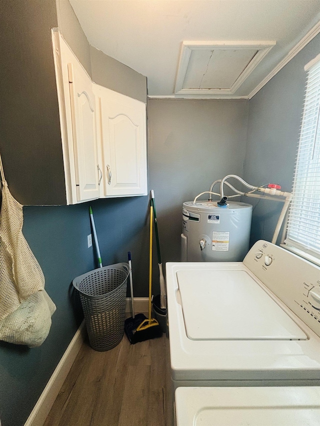 clothes washing area with water heater, dark hardwood / wood-style flooring, and cabinets