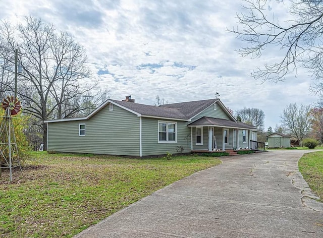 view of front of house with a front yard and covered porch