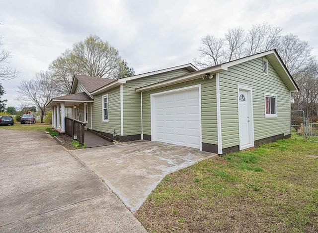 exterior space featuring a garage and a lawn