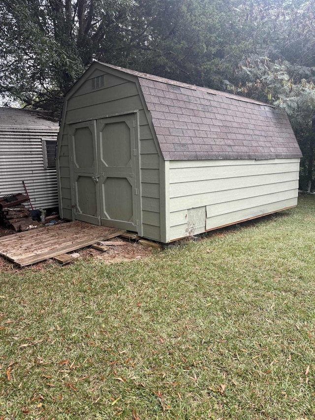 view of outdoor structure featuring a lawn