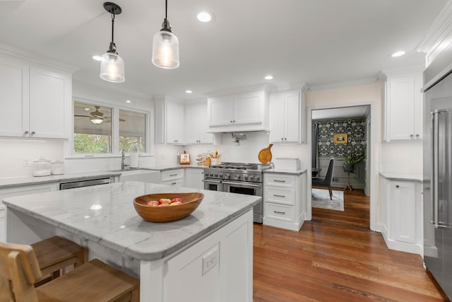 kitchen with white cabinetry, sink, a center island, and appliances with stainless steel finishes