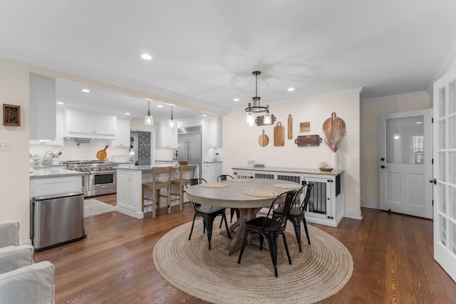 dining space featuring crown molding and dark hardwood / wood-style flooring